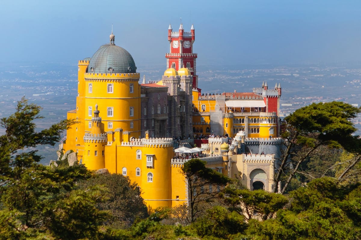 Pena Palace — the yellow-and-red Romantic castle perched on a forested hill 530 metres above Sintra, Portugal